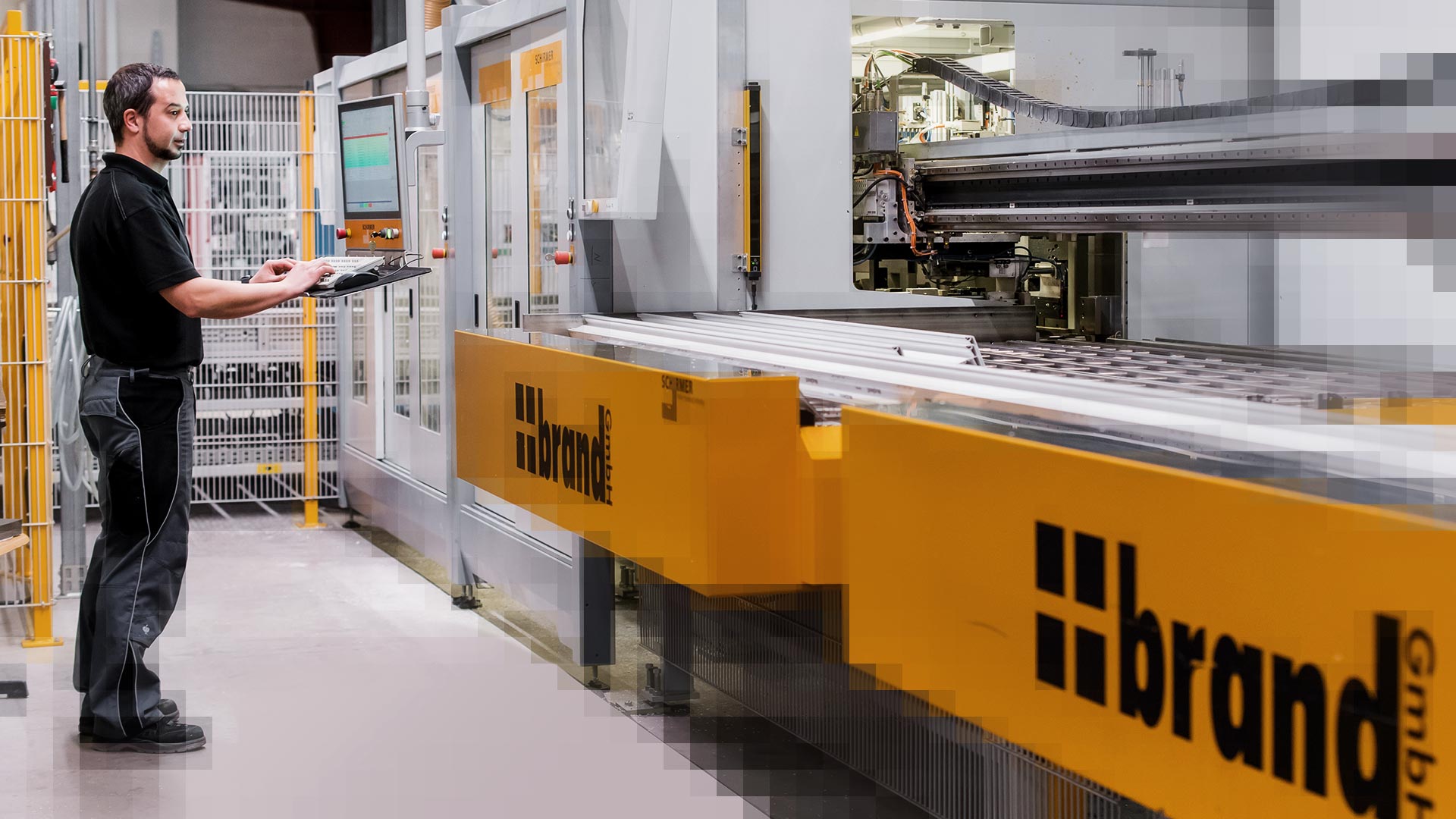 Brand employee operates the HMI of the Schirmer profile processing machine