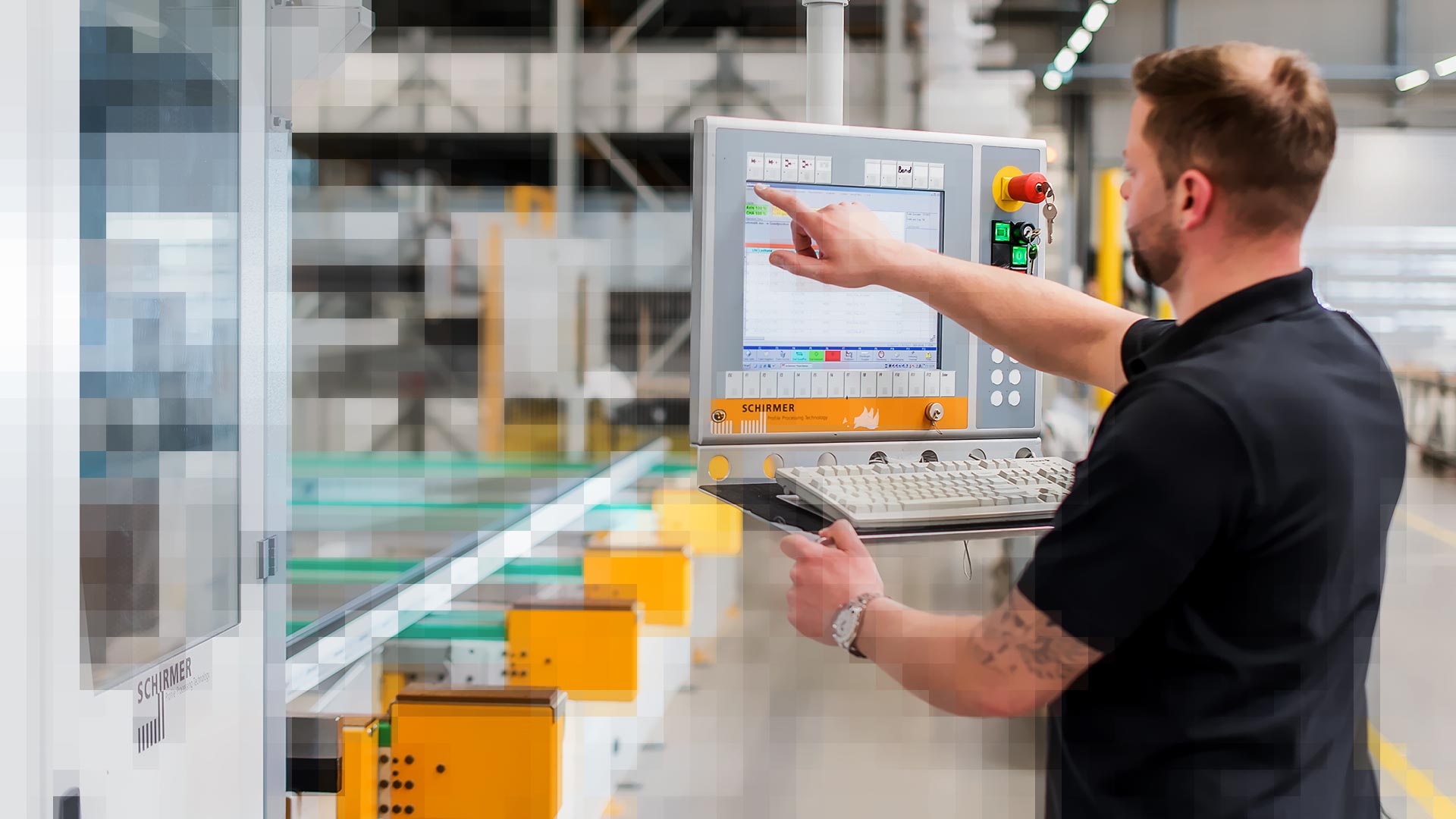 Brand employee stands at a Schirmer profile processing machine and operates the HMI